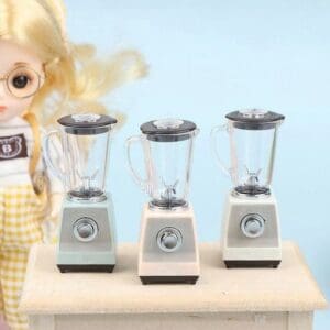 Three miniature blenders on a table with a blurred doll in the background.