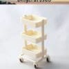 Cream-colored three-tier mobile storage cart on a light background.