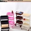 Four colorful, three-tier plastic utility carts on wheels, each holding different small items.