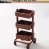 Brown three-tier rolling cart on white background.