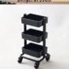 Black three-tier rolling cart with wheels on a light background.