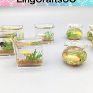 Miniature fish tanks with colorful fish figurines and green plants in various glass containers.