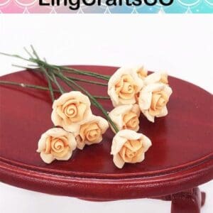 Peach-colored clay roses on a small red table, with "LingCraftsCO" text above.