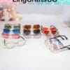 Colorful heart-shaped and round sunglasses displayed on a white surface.