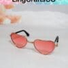 Heart-shaped pink sunglasses with gold frames on a light surface, featuring LingCraftsCO logo above.