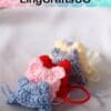 Colorful crocheted bear keychains in a row, featuring blue, pink, red, gray, and yellow.
