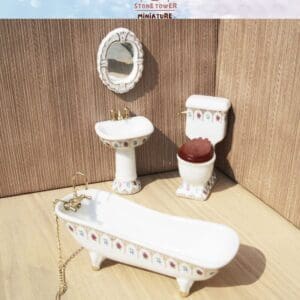 Miniature bathroom set with a bathtub, sink, toilet, and mirror, featuring floral patterns on a wooden surface.