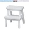 White miniature two-step stool with a simple design on a white background.