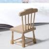 Miniature wooden chair with spindle backrest on a light surface, blurred background, "Stone Tower Miniature" text above.