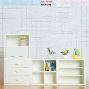 Miniature white shelves with books and potted plants against a tiled wall, labeled "Stone Tower Miniature.