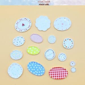 Miniature plates with various colorful patterns on a light yellow background.