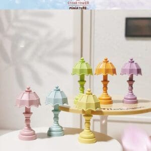 Colorful miniature lamps in pastel shades displayed on small round tables indoors.