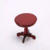 A small, round, dark red wooden pedestal table with a tripod base on a white background.