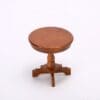 Small wooden round side table with a pedestal base, set against a white background.