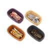 Four woven baskets with assorted metallic utensils in different colors: rose gold, silver, gold, and bronze.