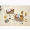 Miniature bathroom set with towels in baskets, toiletries, mirror, and comb on a cream surface, labeled with dimensions.