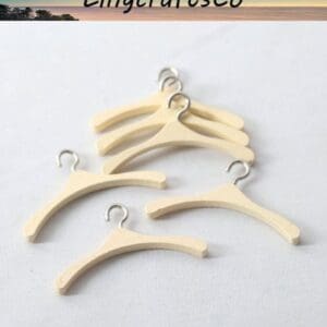 Six small wooden hangers with metal hooks on a white surface under a LingcraftsCo branding banner.