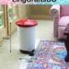 Miniature trash can with a red lid, 44mm tall and 32mm wide, placed on a colorful rug next to a pink chair.