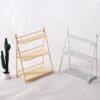 Two miniature wooden shelf units, one natural and one white, next to a small potted cactus on a white background.
