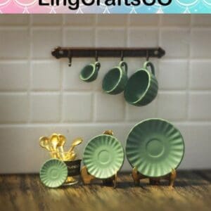 Miniature green dish set with cups and plates displayed on a white tiled wall, with spoons in a gold holder.
