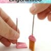 Hands holding a miniature pink broom and dustpan against a white background with "LingCraftsCO" text above.