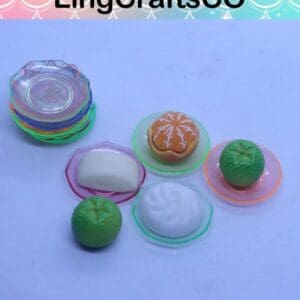 Colorful miniature plates with food items, including buns and green vegetables, displayed on a blue background.