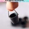 Finger holding tiny metal bucket against a blurred background with the text "LingCraftsCO" above.