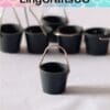 Small black metal buckets with handles on a white surface, displayed under the LingCraftsCO brand logo.