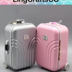 Two mini suitcase-shaped boxes, one silver and one pink, with handles and wheels, by LingCraftsCO.