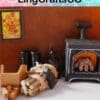Miniature cozy room scene with a stove, logs, lantern, and framed floral painting on a brown wall, labeled "LingCraftsCO.