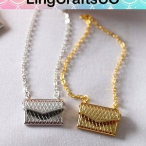 Two quilted mini handbag necklaces in silver and gold on a light surface, by LingCraftsCO.