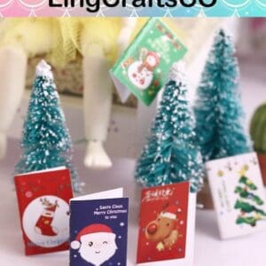 Miniature Christmas cards and frosted trees create a festive scene.