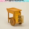 Miniature wooden cart with open door and wheels, displayed on a neutral background.