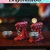Two miniature red polka-dot mixers with bowls on a table, bokeh lights in the background.