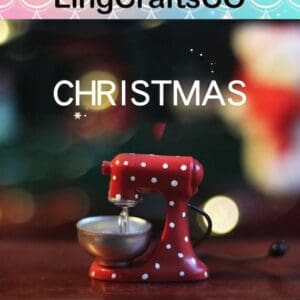Red polka dot mixer ornament with "CHRISTMAS" text, against a blurred festive background.