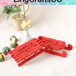 Red wooden sleds with "Merry Christmas" text, surrounded by small toys and a vase with yellow flowers.