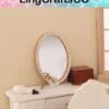 Miniature vintage vanity with round mirror, perfume bottle, and a wooden box on a white dresser.