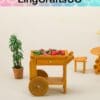 Miniature wooden cart with vegetables, surrounded by small potted plant and furniture, under LingCraftsCO logo.