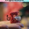 Miniature red polka dot mixer held in a hand against a blurred background, showcasing handcrafted detail.