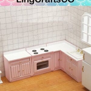 Miniature pink kitchen set with stove, oven, and sink on a wooden floor. White tiled walls and a window nearby.