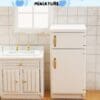 Miniature white kitchen set with a sink, cabinet, and fridge against a tiled wall.