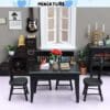 Miniature dining room with black furniture, books, flowers, guitar, and decorative items for a cozy setting.